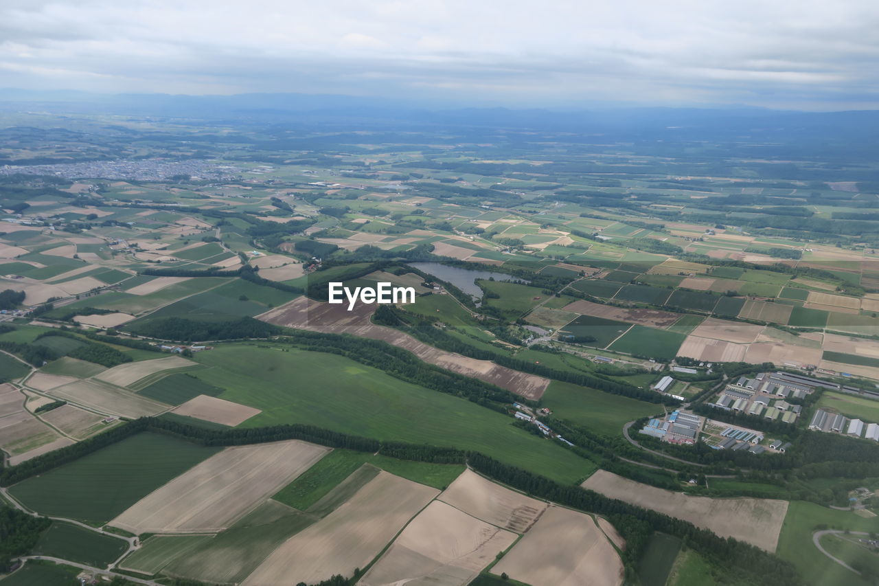 Aerial view of agricultural field against sky