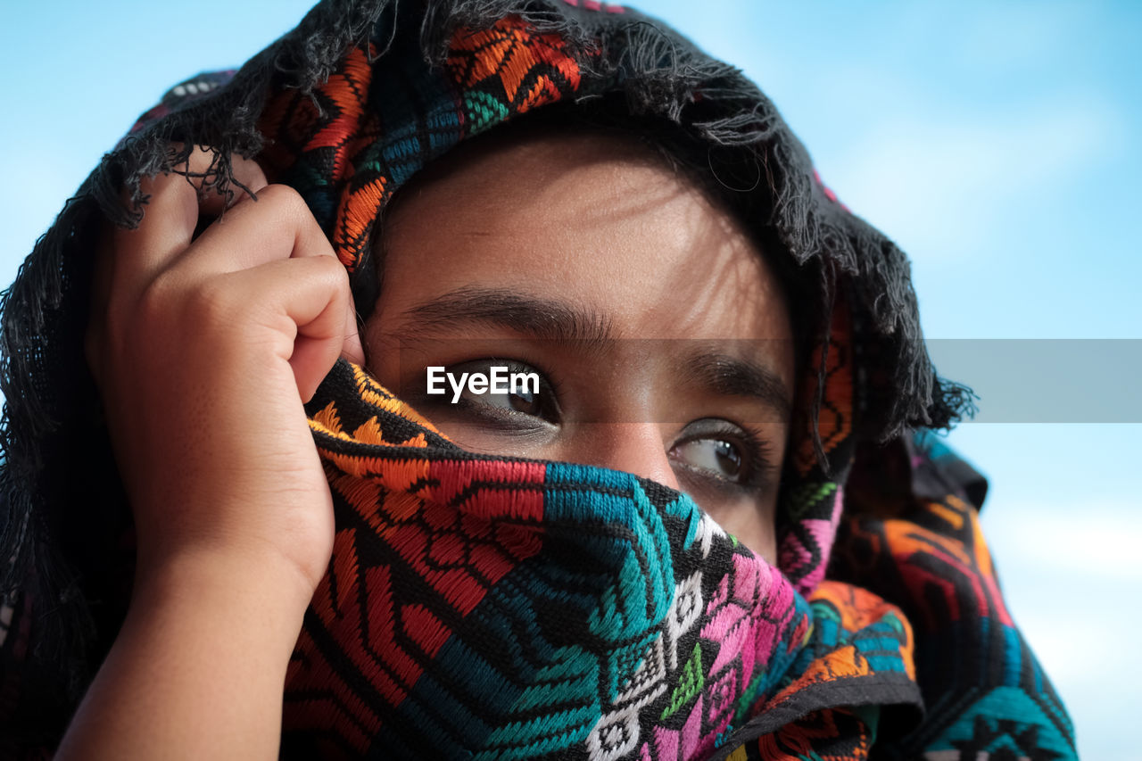 Close-up portrait of girl covering face 