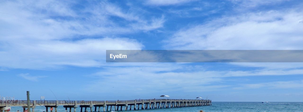 PIER OVER SEA AGAINST BLUE SKY