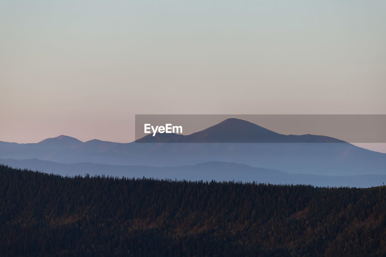 SCENIC VIEW OF MOUNTAINS AGAINST SKY DURING SUNSET