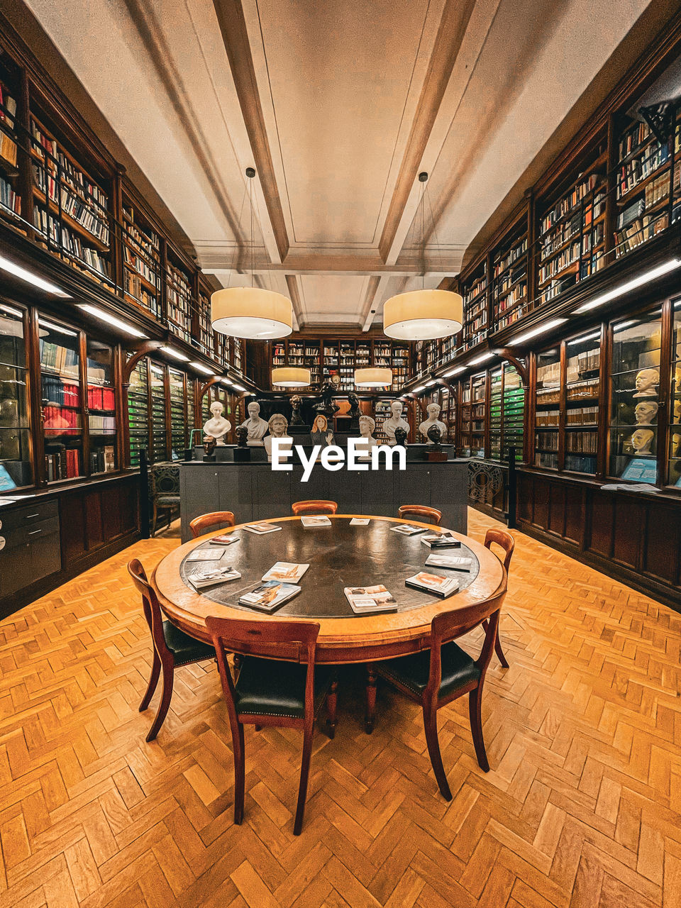 seat, table, indoors, interior design, chair, architecture, food and drink, flooring, library, bookshelf, furniture, recreation room, no people, book, publication, building, built structure, shelf, business, wood
