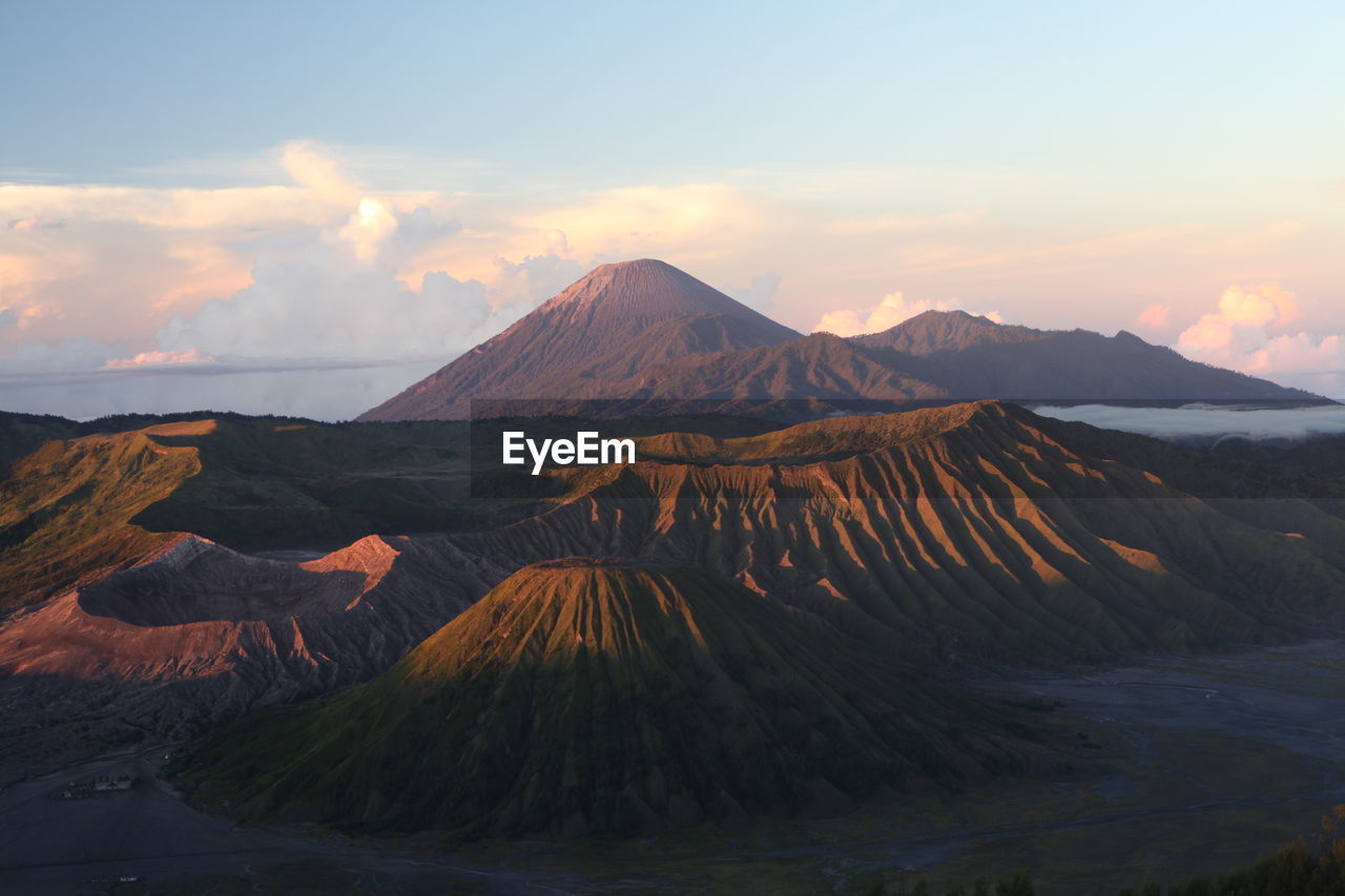 SCENIC VIEW OF MOUNTAINS AGAINST CLOUDY SKY