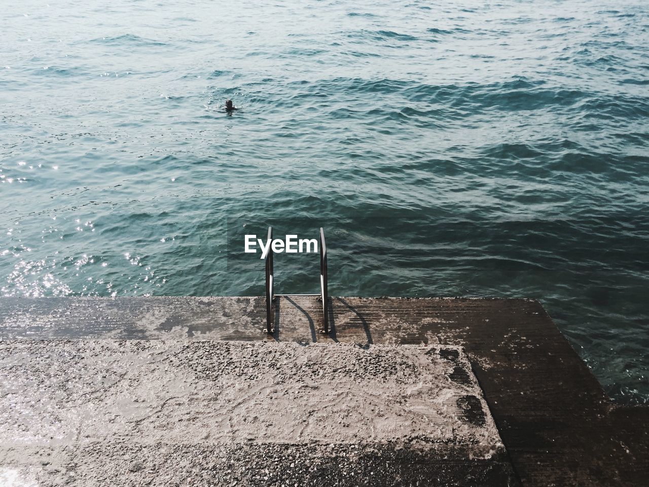 High angle view of ladder on pier by sea