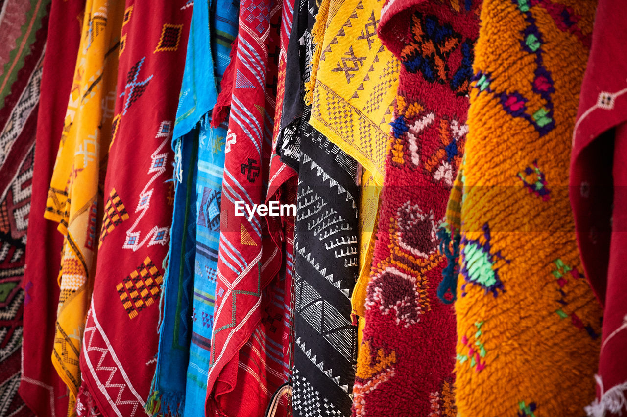 Colorful rugs at a bazaar market stall in morocco, filling the frame