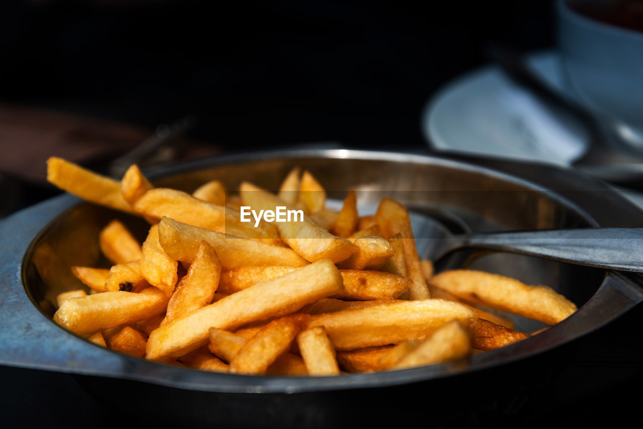 Close-up of french fries in plate on table