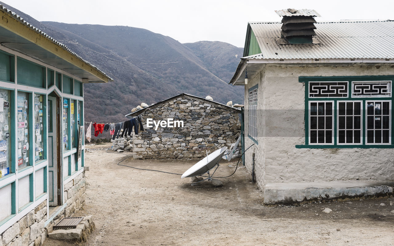 Houses in village against clear sky