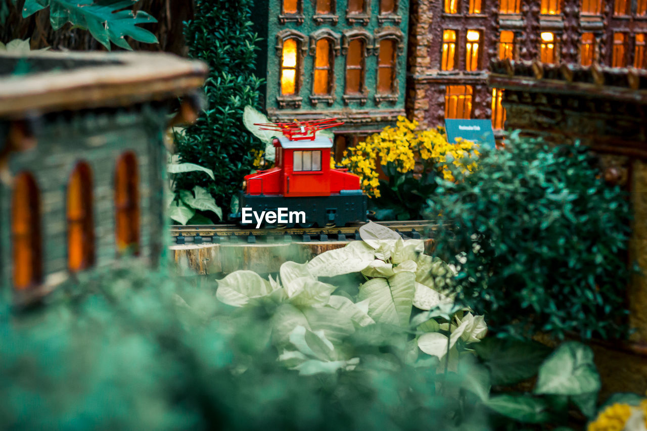 Red model train running through a city