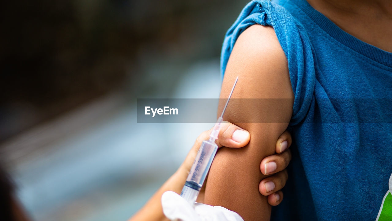 Close-up of doctor giving injection to patient