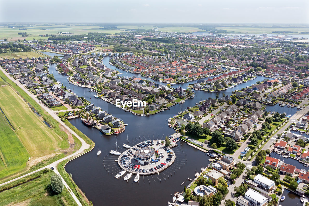 Aerial top shot from houses with boats in friesland the netherlands