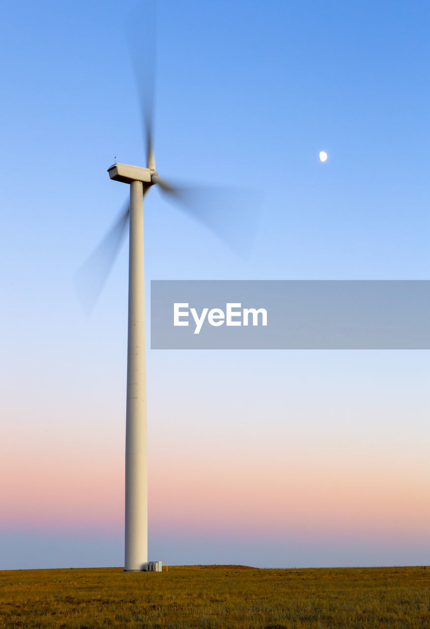 Colorado wind farm located on wheat field at sunset