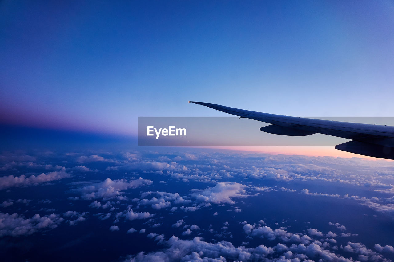 Aerial view of airplane flying in sky