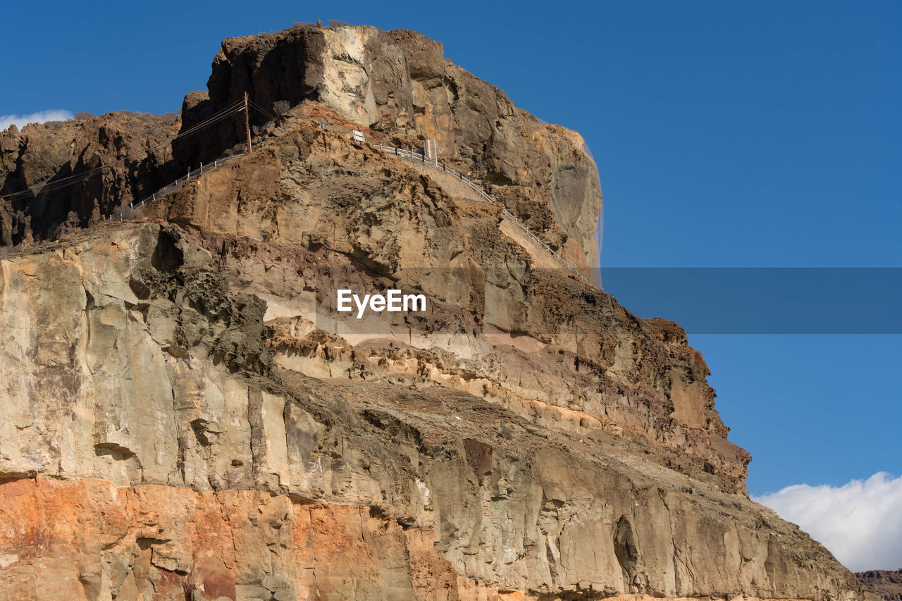 LOW ANGLE VIEW OF ROCK FORMATION AGAINST SKY