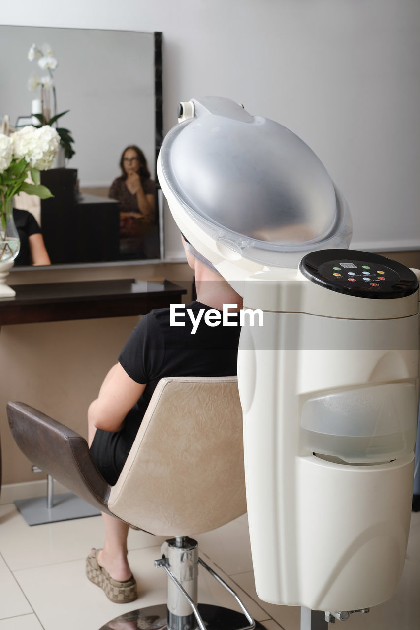 Hair professional treatment in salon. using steam to dilate the pores of scalp. help to combat hair