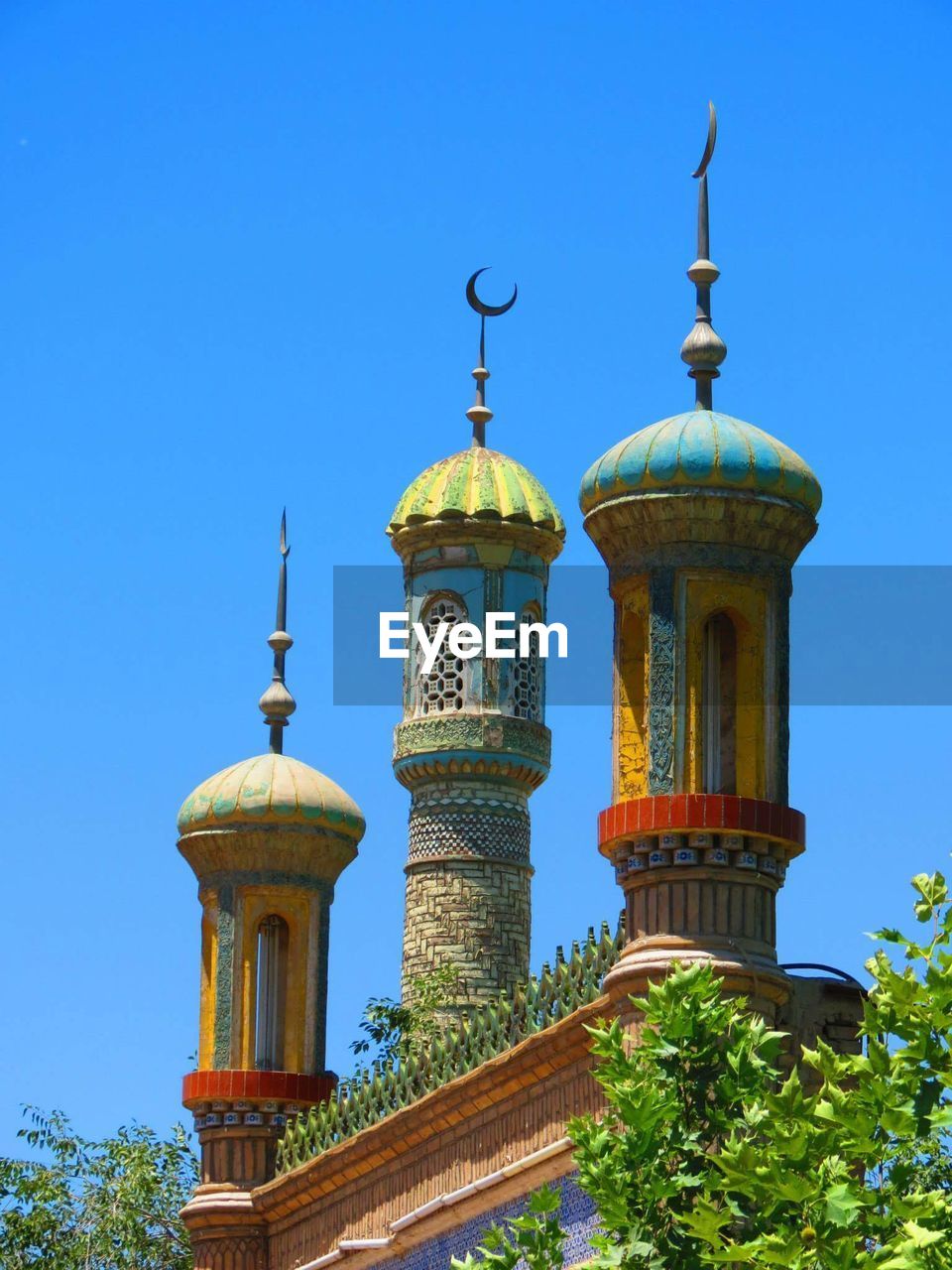 High section of built structure against clear blue sky