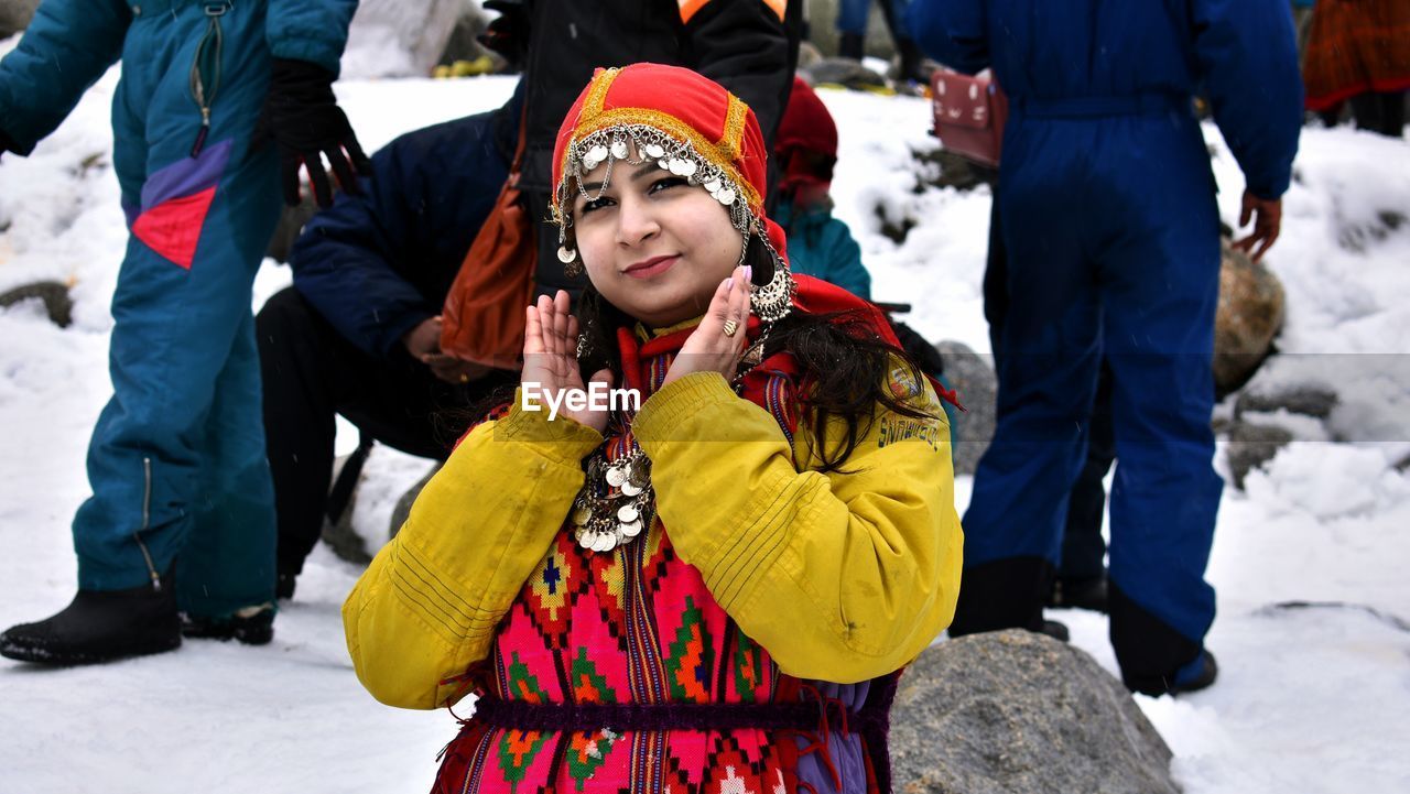 Women standing on snow covered field in manali / india 