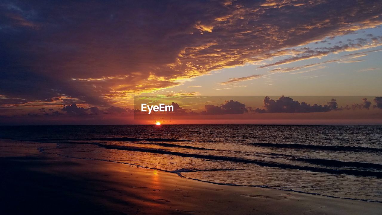 Scenic view of sea against sky at sunset