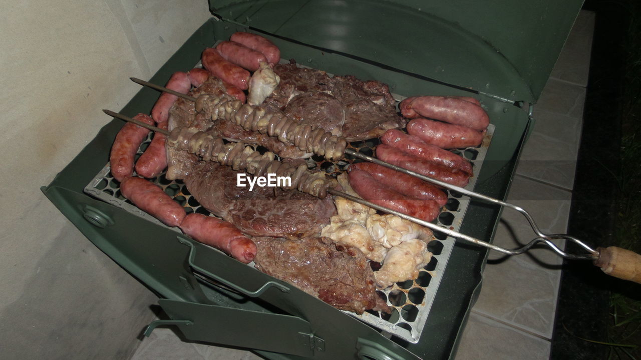 High angle view of meat on barbecue grill