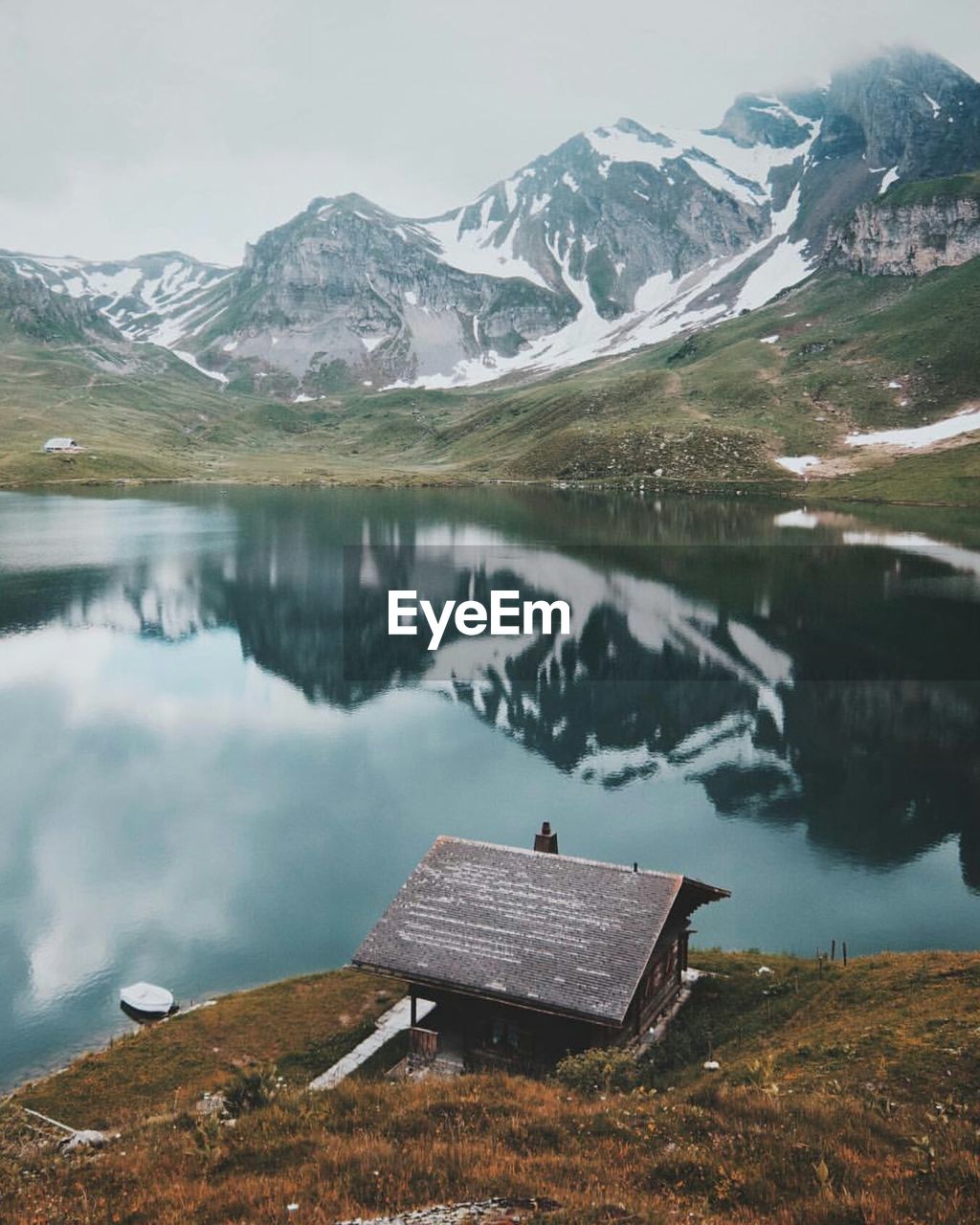 SCENIC VIEW OF LAKE WITH MOUNTAINS IN BACKGROUND