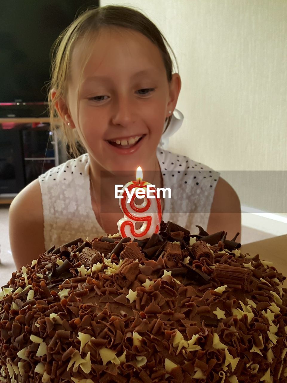 Smiling girl celebrating birthday at home