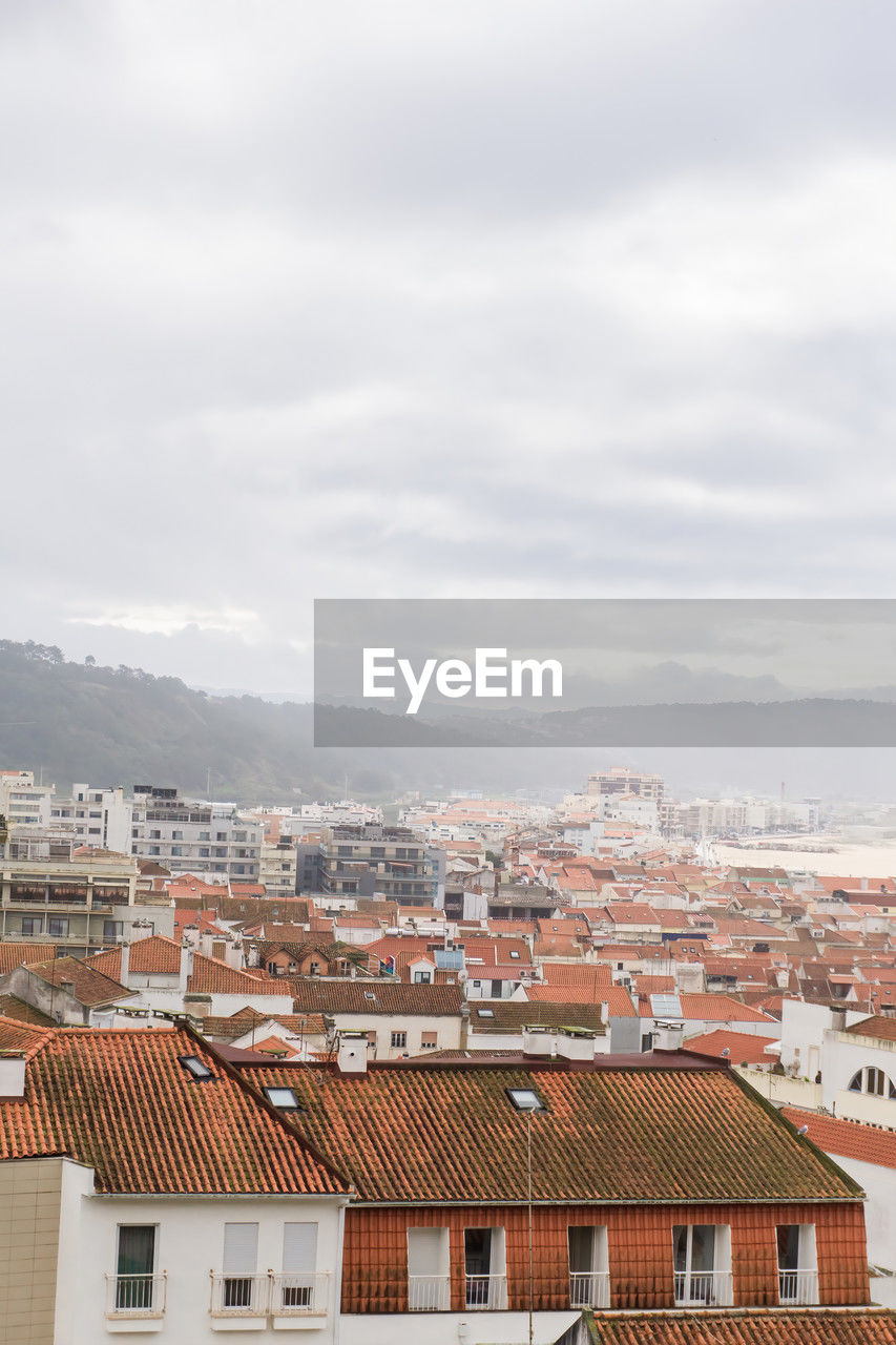 Iew of the streets with white houses and orange tiled roofs, an ancient portuguese city on the ocean