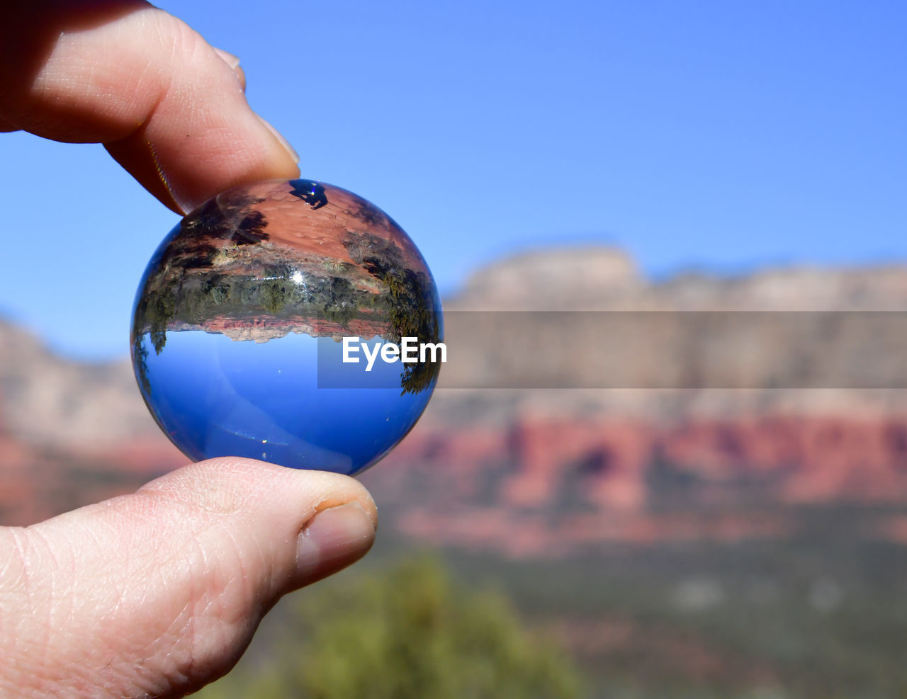 Desert landscape mirror image seen in glass ball