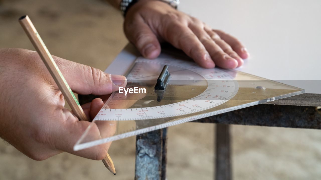 Cropped hands of man working on table