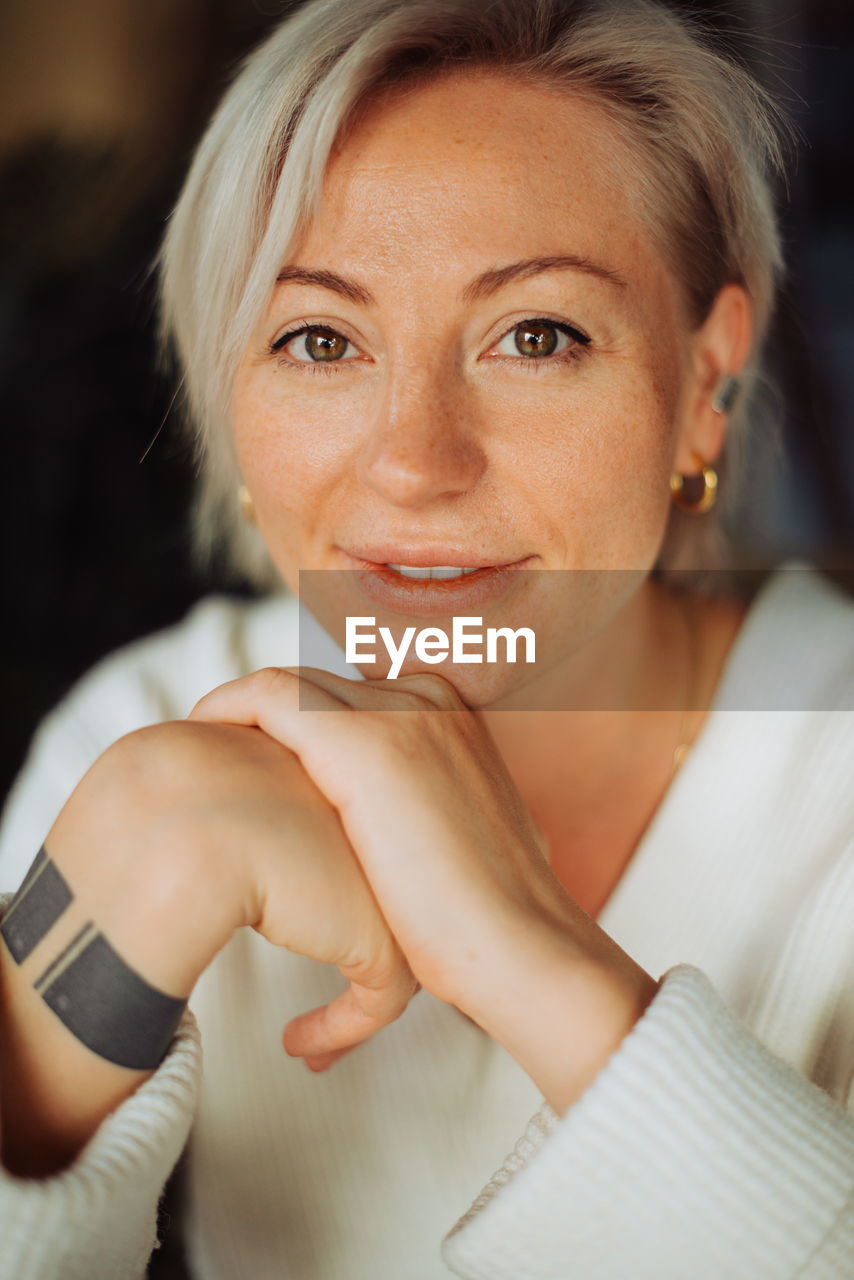 Headshot of a blond woman with short hair looking at camera