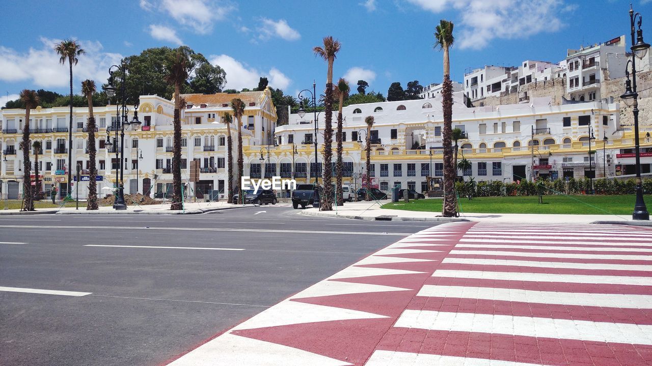 City street by buildings against sky