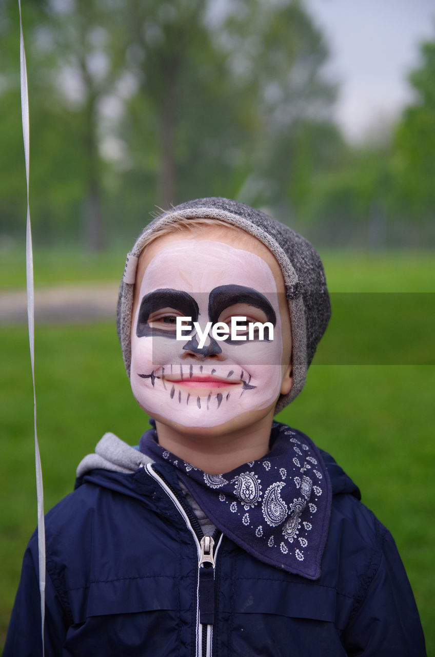 Close-up portrait of smiling boy with face paint