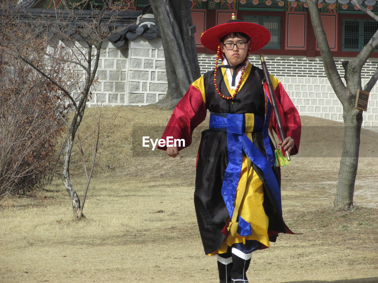 Portrait of man in costume walking on lawn