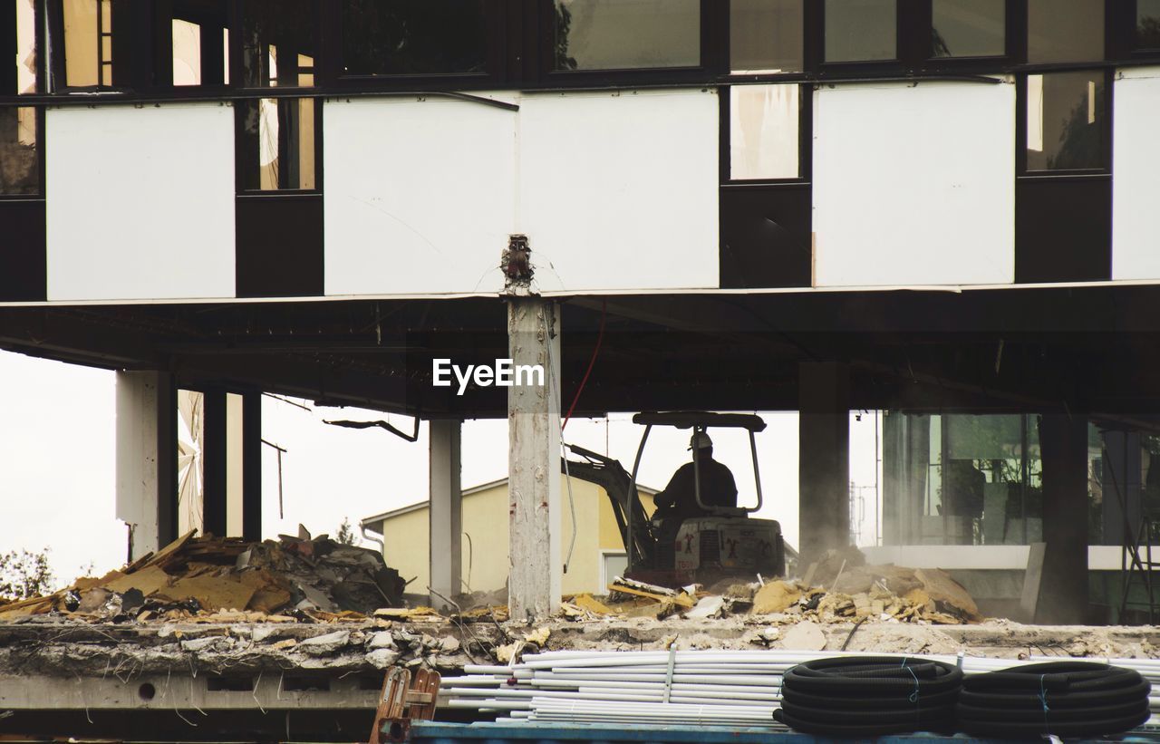 MAN SITTING ON BUILDING