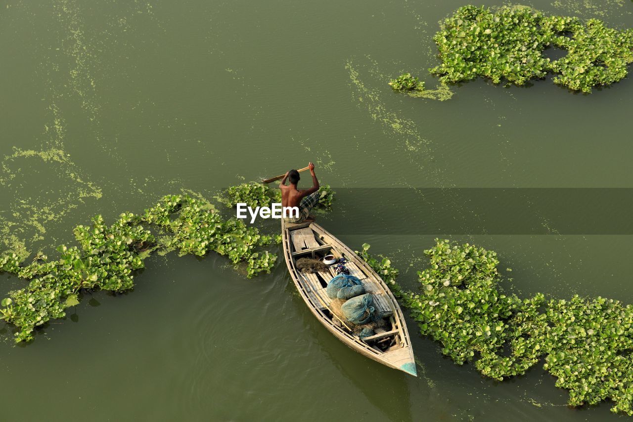 High angle view of man floating on lake