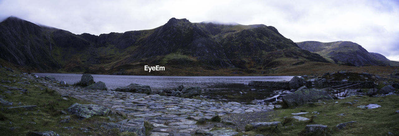 Scenic view of land and mountains against sky