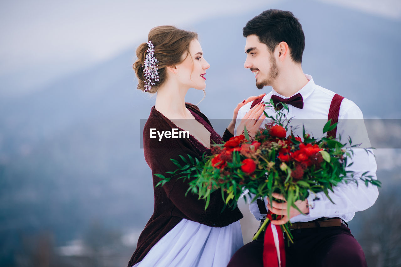 MAN AND WOMAN HOLDING FLOWER