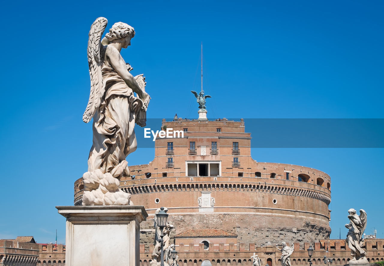 Statues at castel sant angelo against clear blue sky
