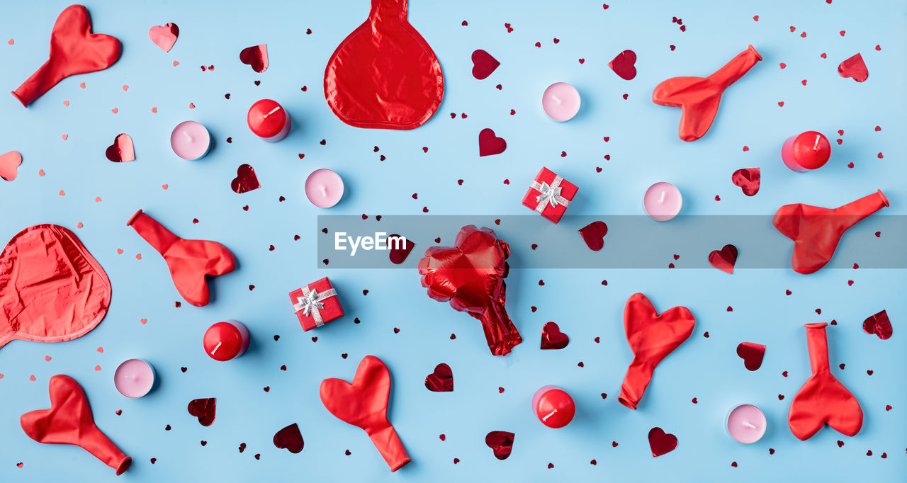 Valentines day. red decorations balloons, candles, confetti and gifts top view flat lay 