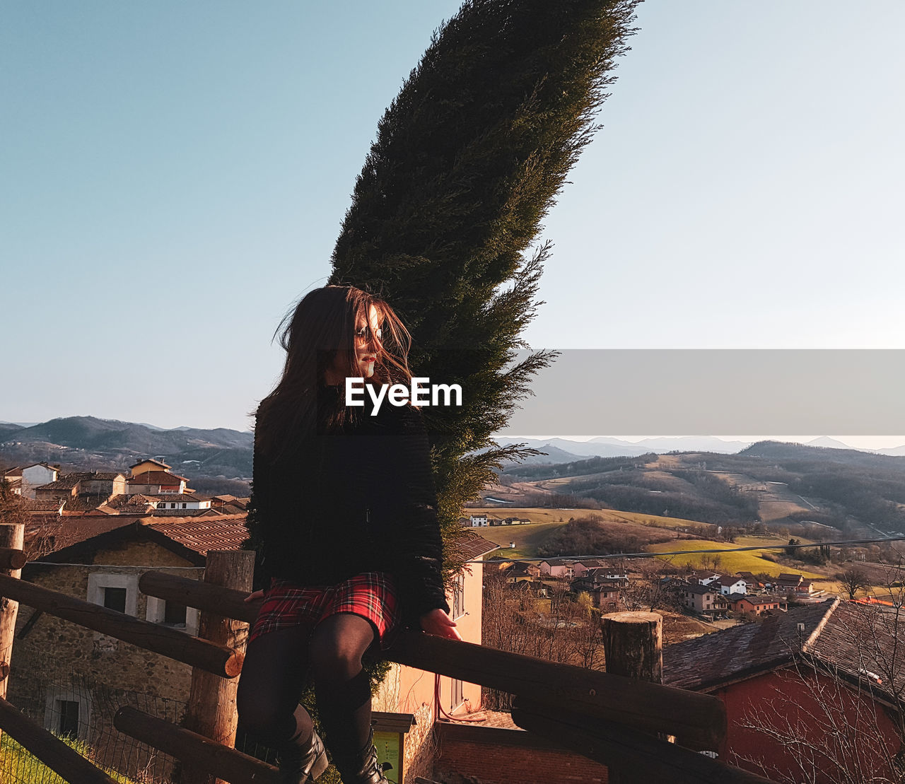 Woman looking at mountain range against clear sky