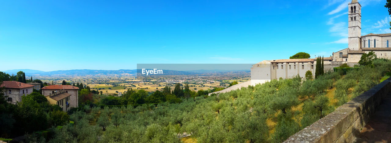 Panoramic view of old building in city against clear blue sky