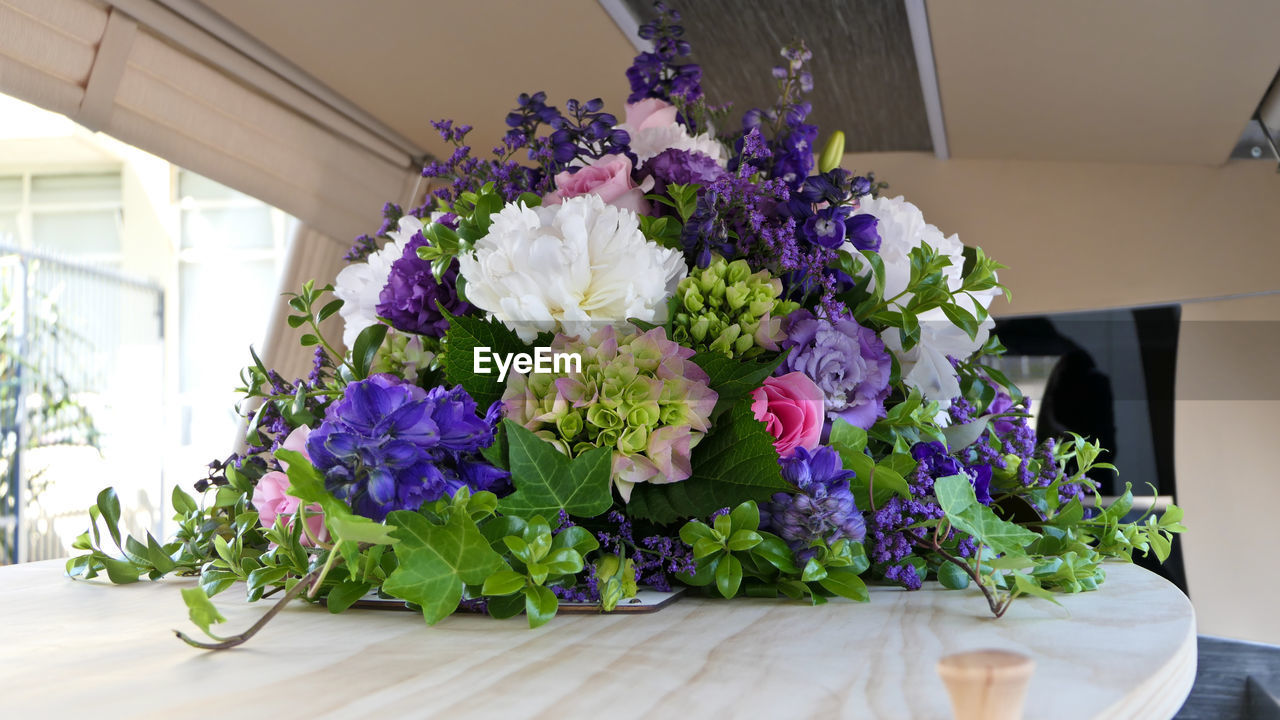 Closeup shot of a funeral casket or coffin in a hearse or chapel or burial at cemetery
