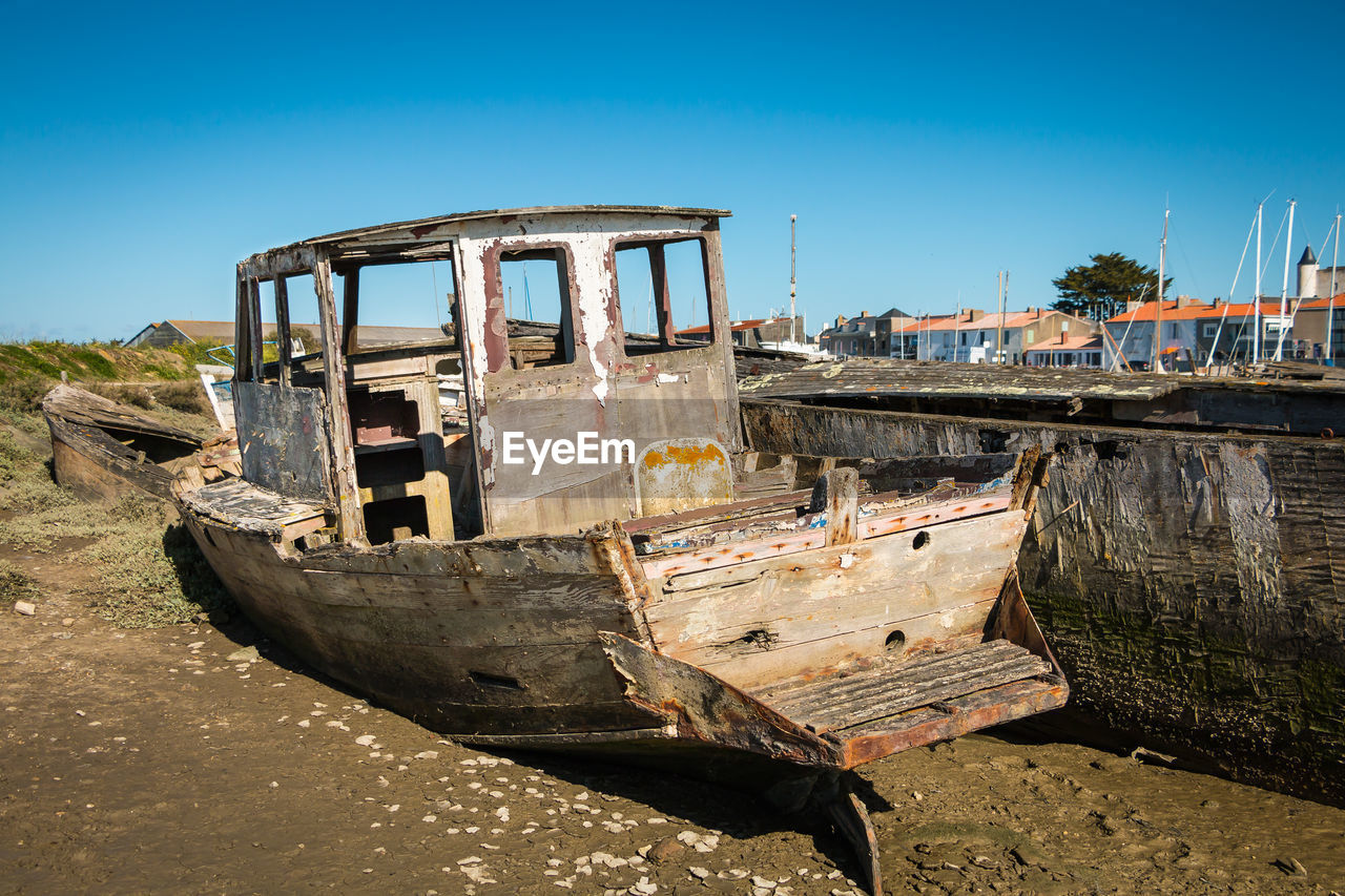 ABANDONED BOAT AGAINST CLEAR SKY