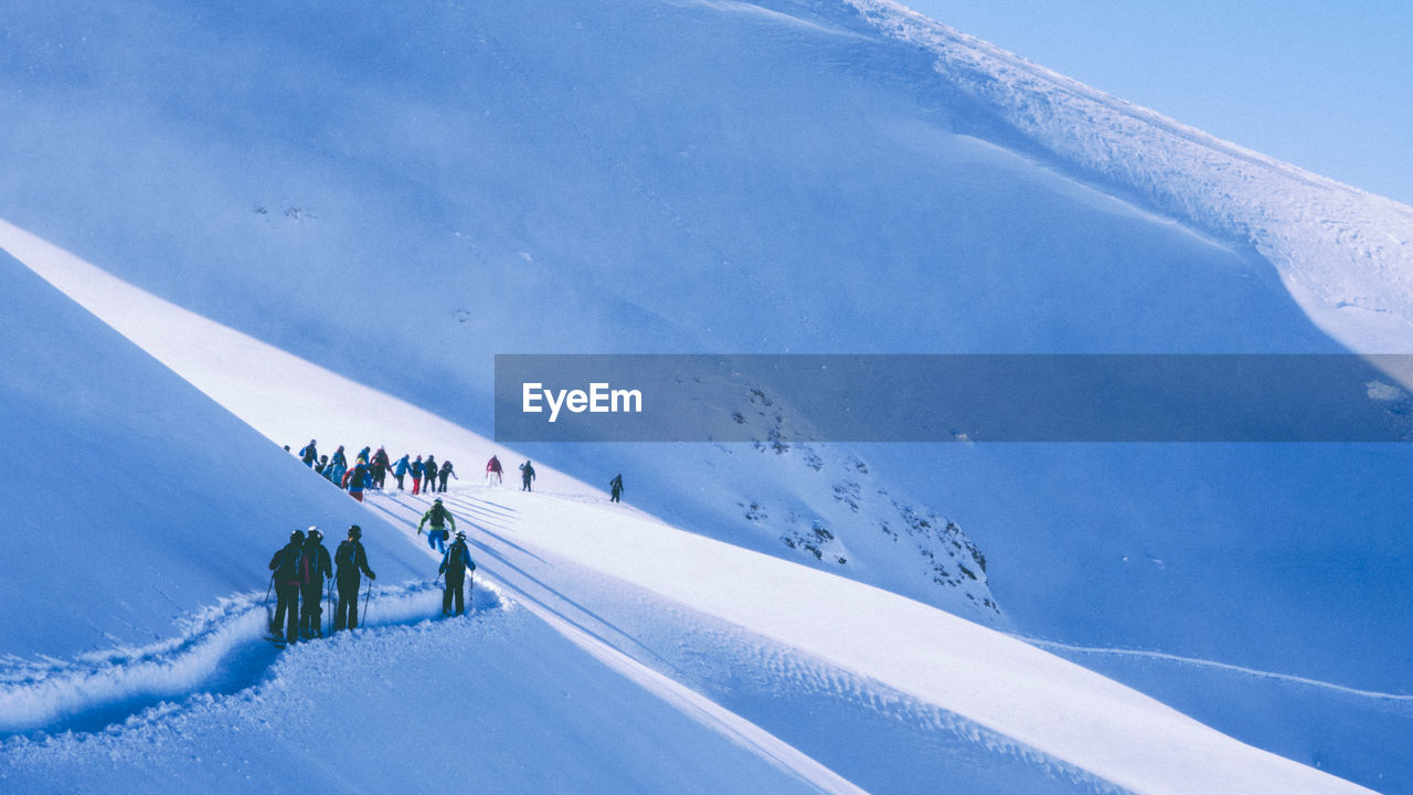 People skiing on snowcapped mountains