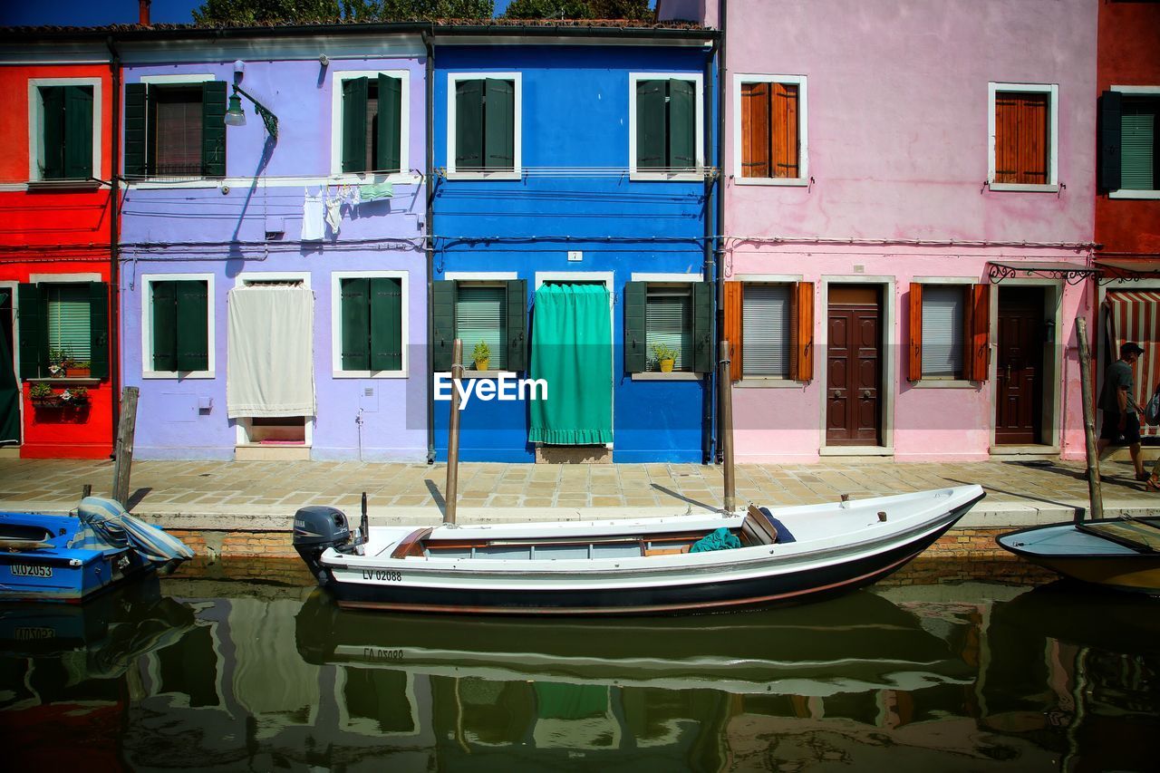 Buildings by canal in city