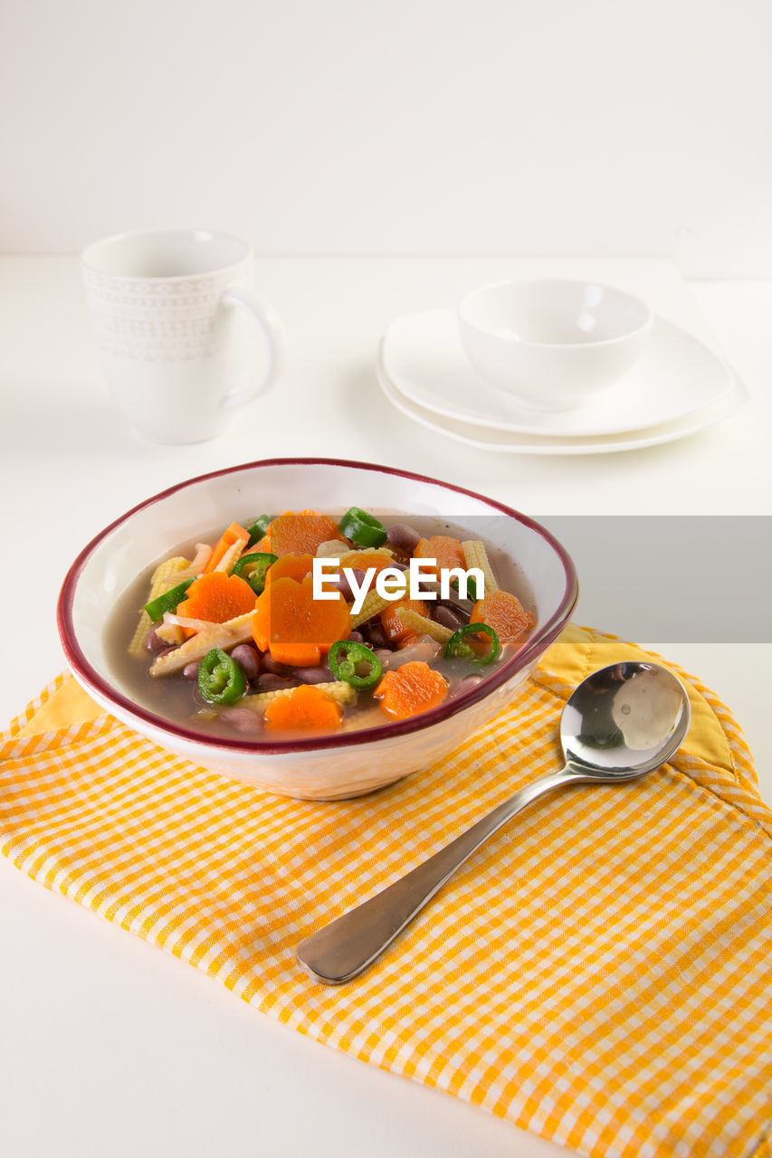 Close-up of vegetable soup served in bowl on table
