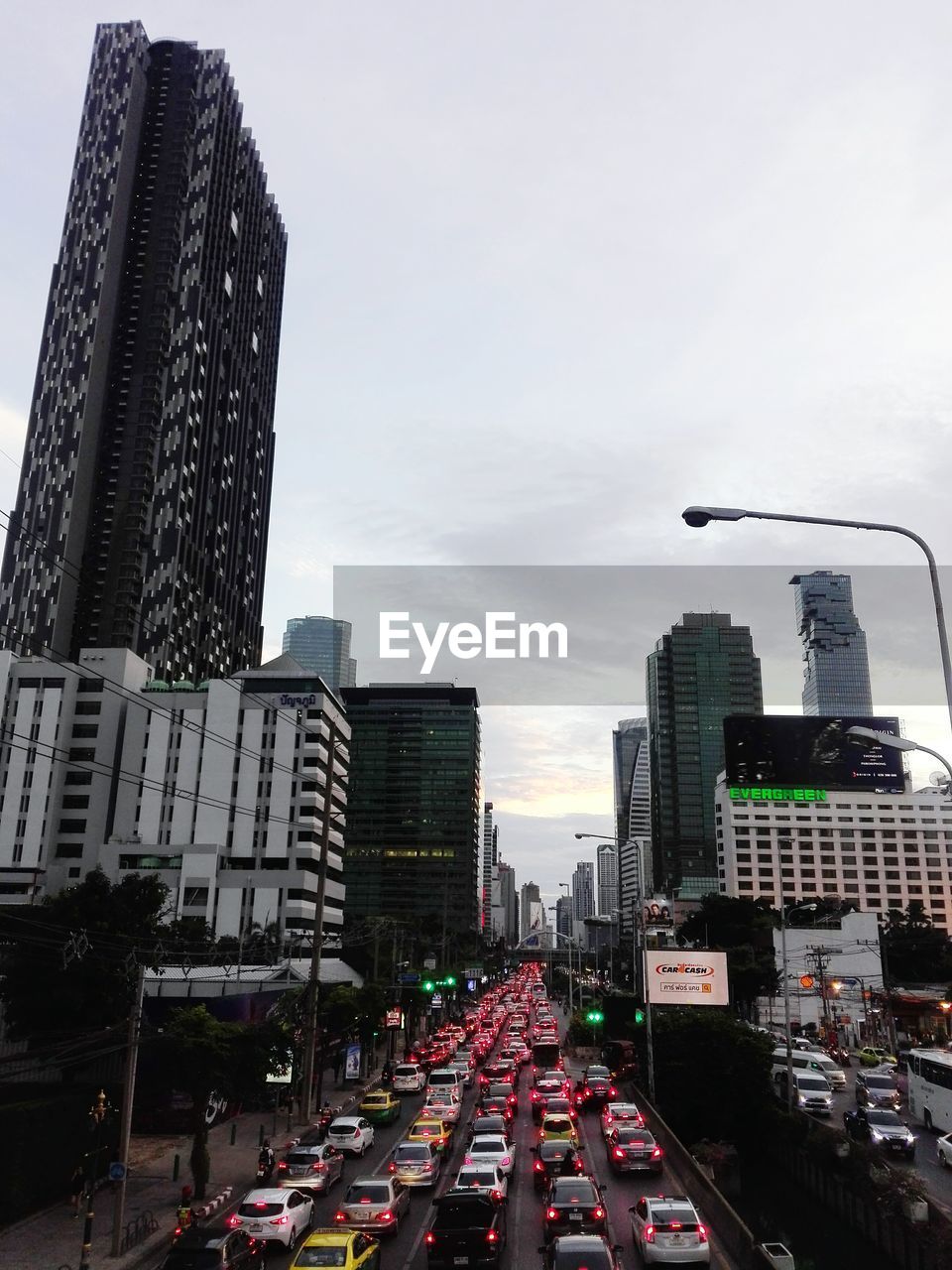 VIEW OF CITY STREET AND MODERN BUILDINGS AGAINST SKY