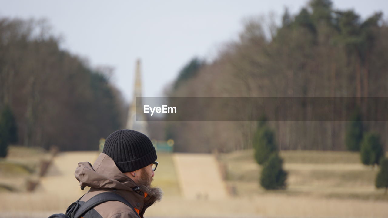 Side view of man wearing warm clothing in park