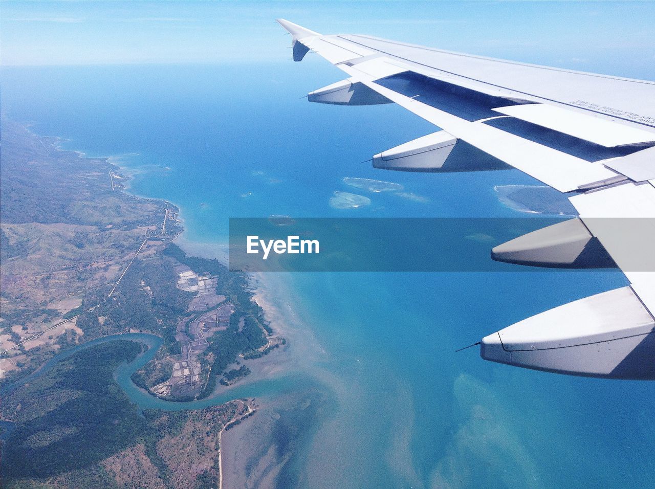 AERIAL VIEW OF AIRPLANE WING OVER LANDSCAPE