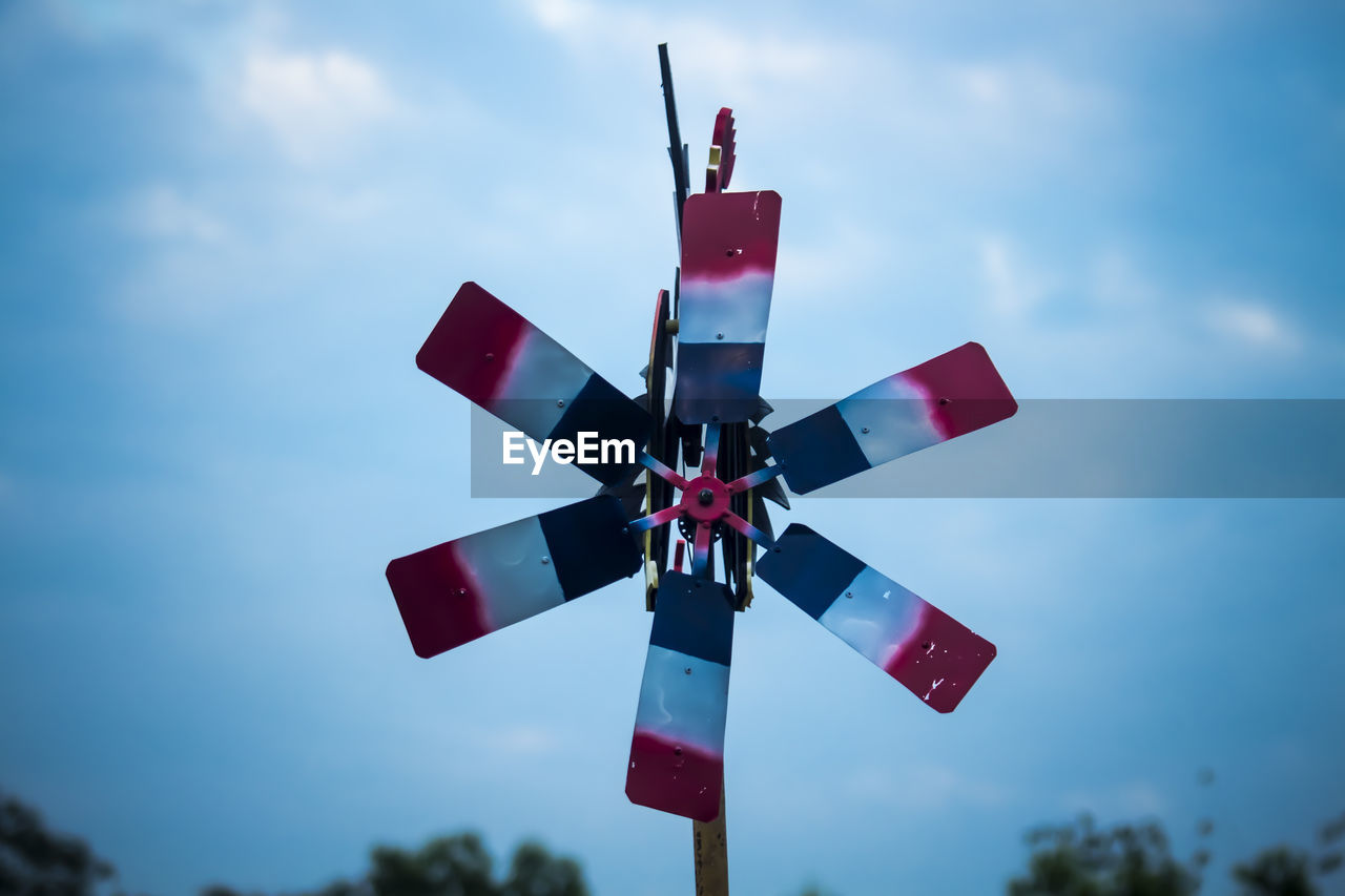 Low angle view of flag flags against sky