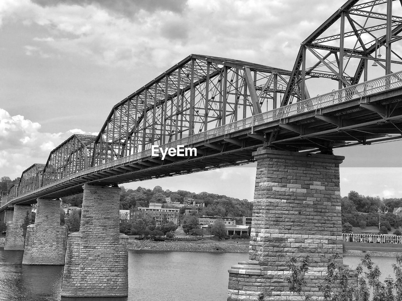 Low angle view of bridge over river against sky