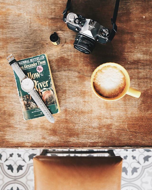 CUP OF COFFEE ON WOODEN TABLE