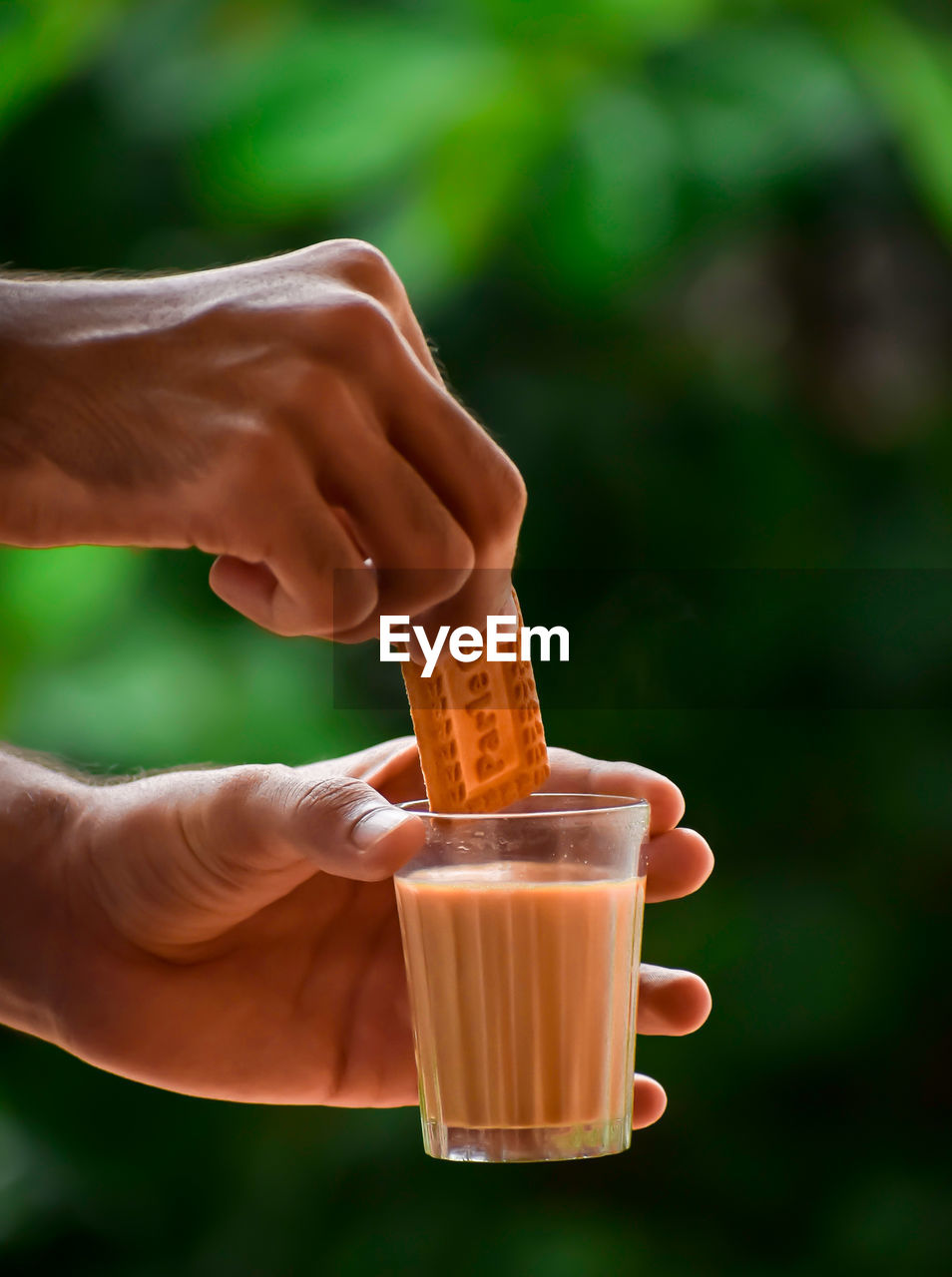 CLOSE-UP OF HAND HOLDING CUP